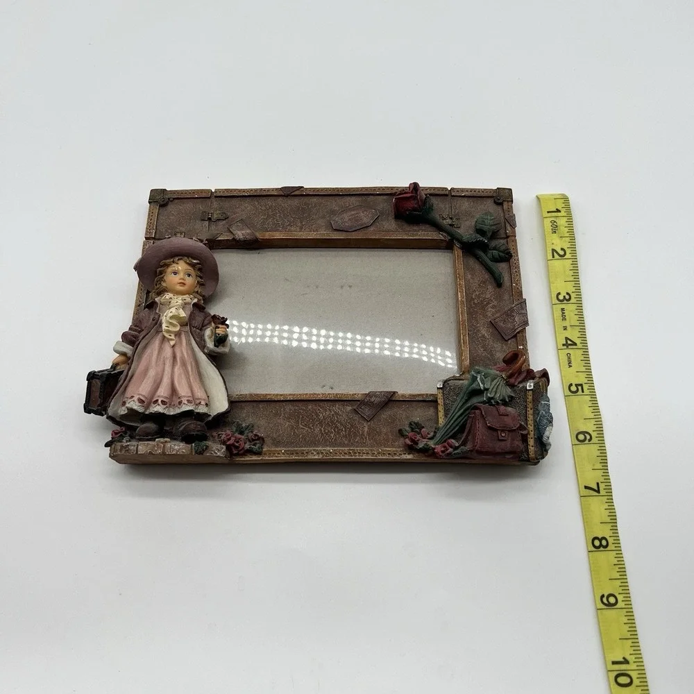 A Richesco Corporation Girl With Roses Suitcase Hand Painted Resin picture frame